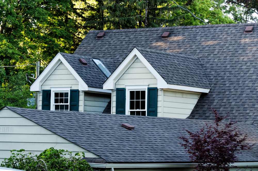 A shingle roof with two dormer windows.